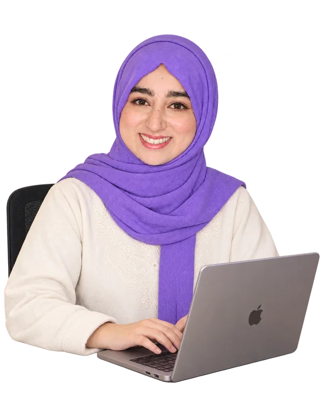Kiran Fatima smiling at her laptop
